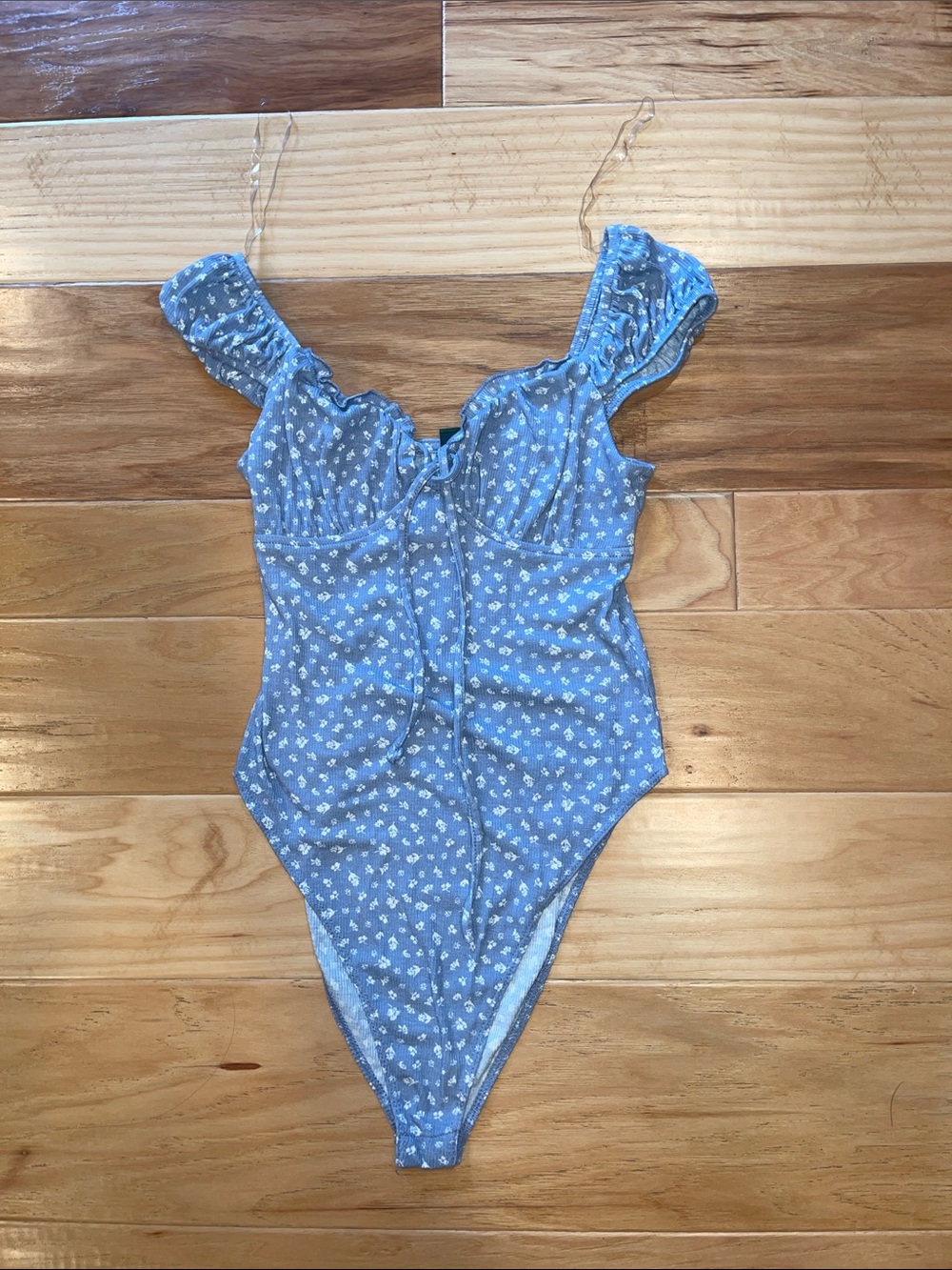 Pastel blue and white floral bodysuit with clips